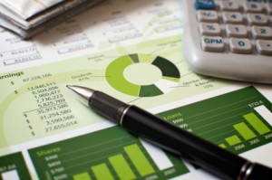 Pen, Calculator, and Financial Charts